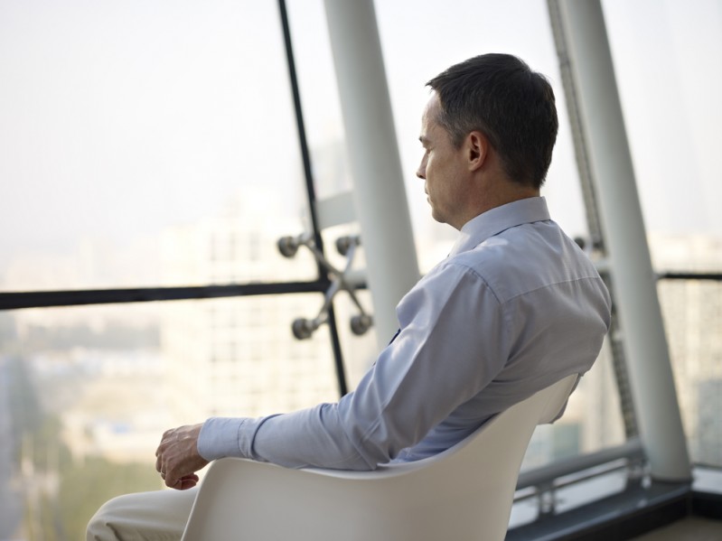 Man looking out of window reflecting