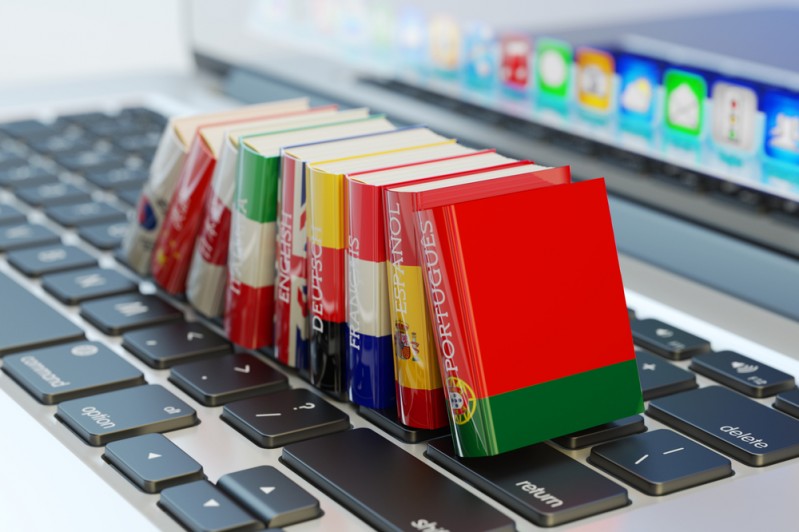 A selection of translation books on a laptop keyboard