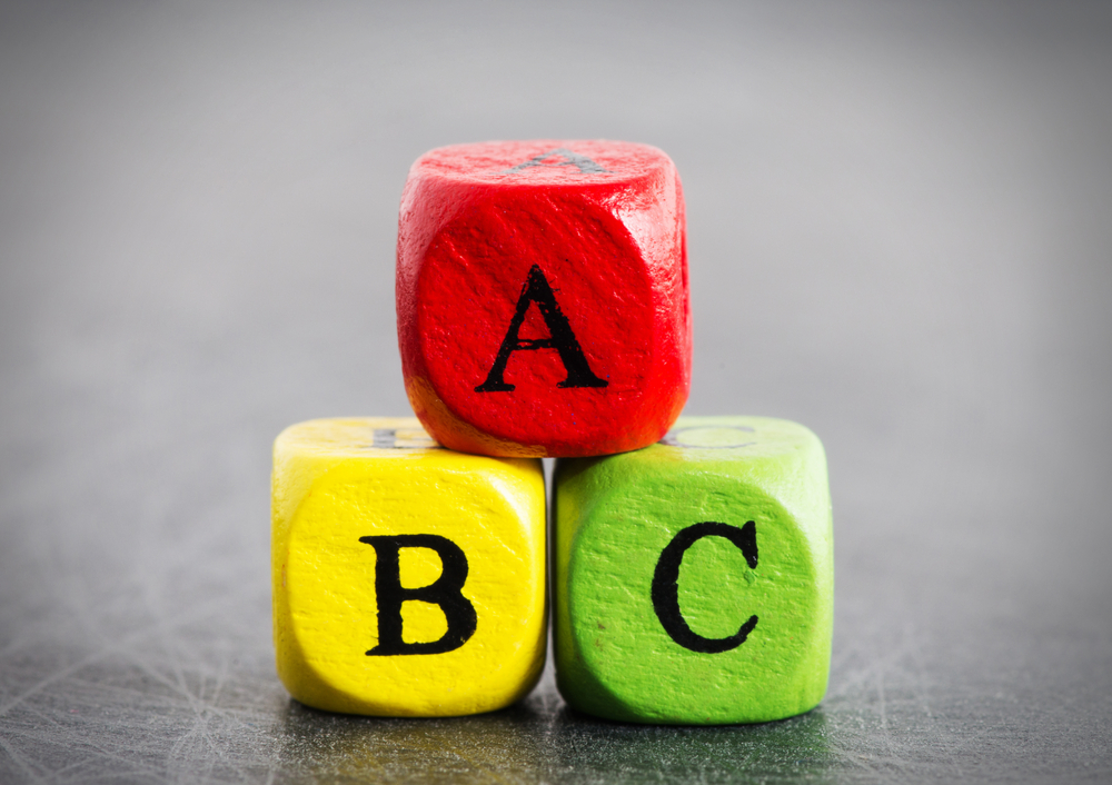 3 multicoloured die with the letters A, B, and C written on them