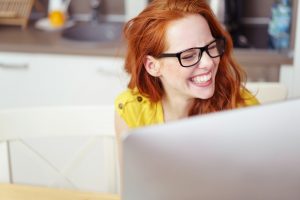 lady laughing at computer
