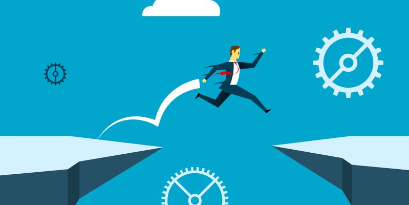 Man jumping between cliffs representing skills gap