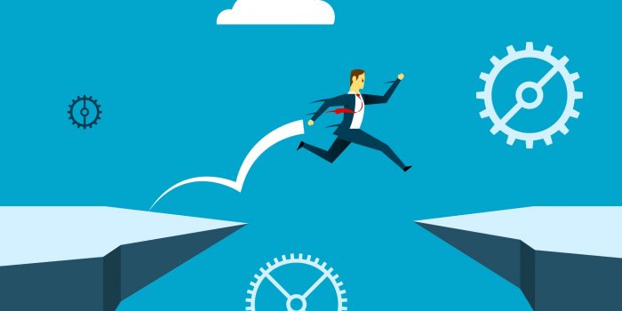 Man jumping between cliffs representing skills gap
