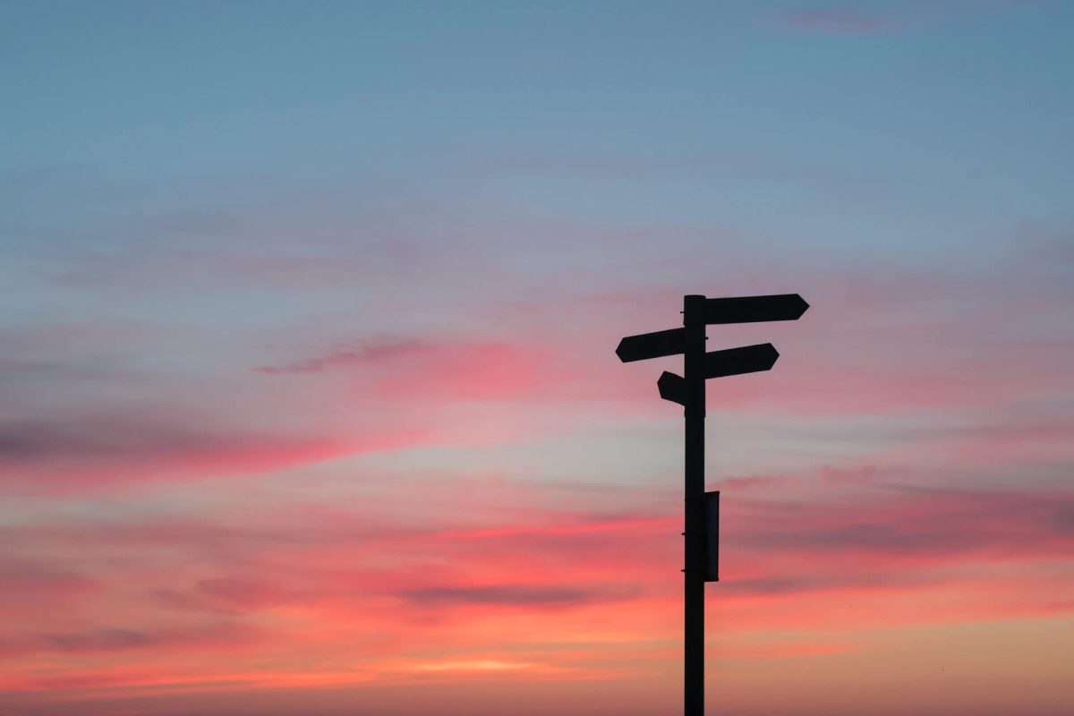 sunset with signs pointing in different directions symbolising opportunities for skills development
