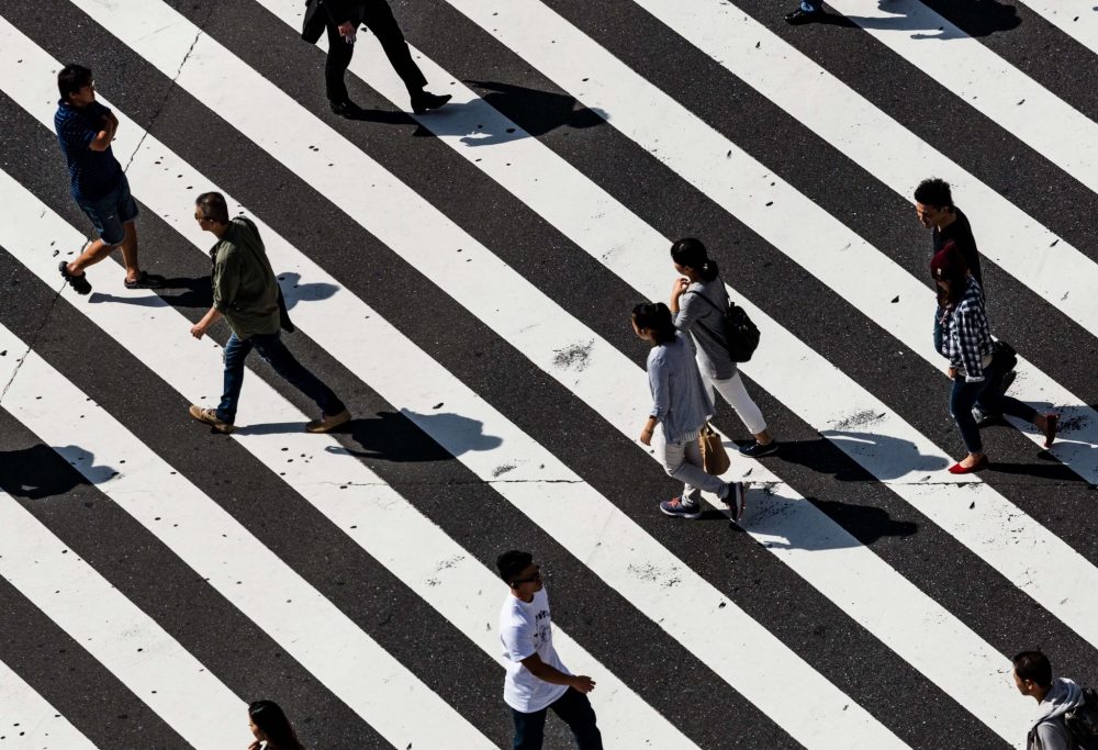 people walking over crosswalk