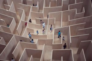 people walk through a maze with overconfidence