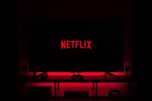 Netflix logo on a television screen surrounded by red light