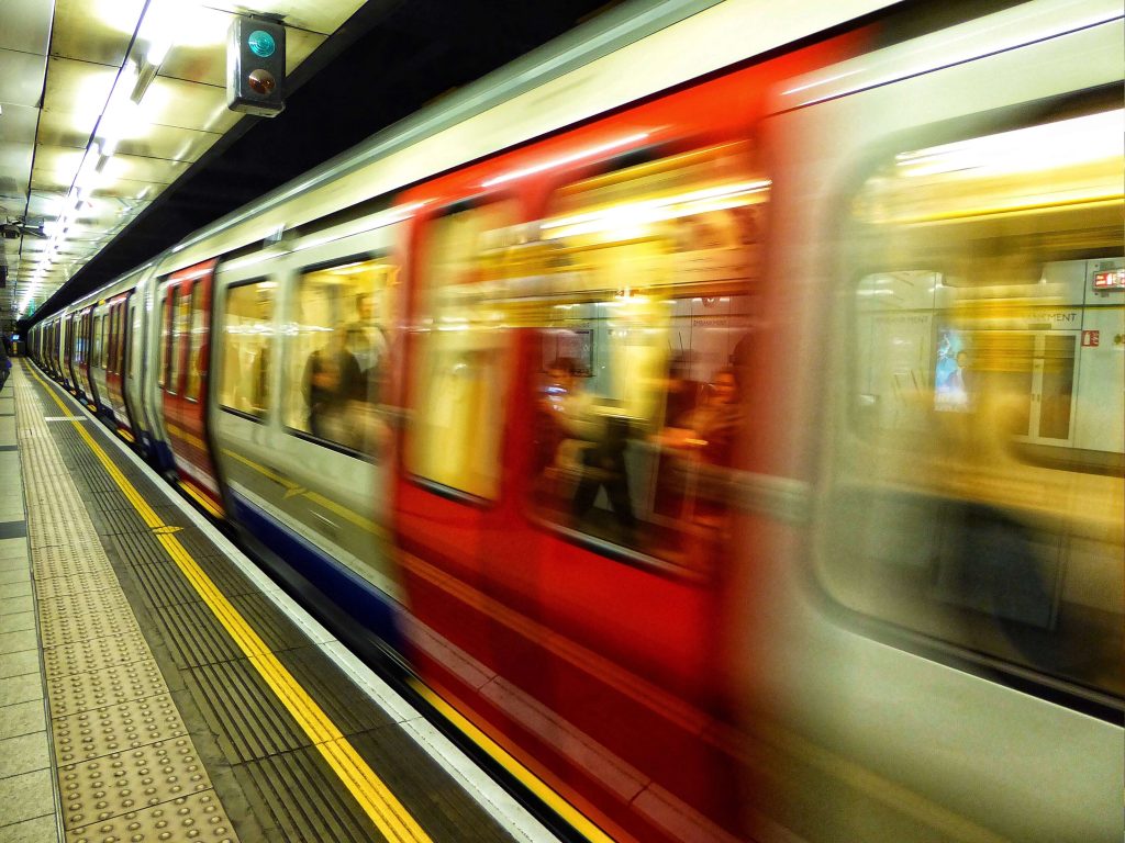 tube train moving quickly through a station