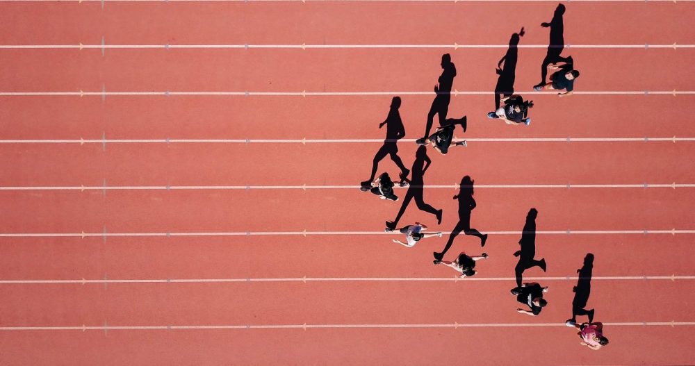 People being coached and running on a track